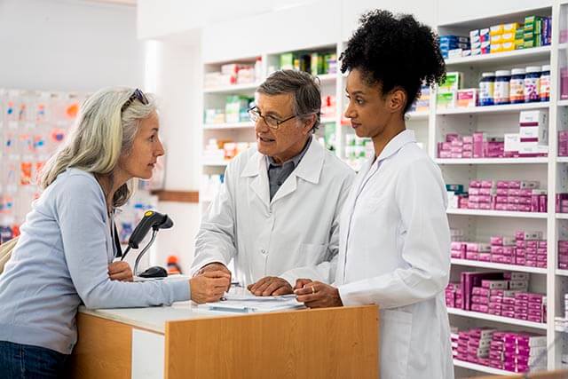 Pharmacy staff speaking to a customer