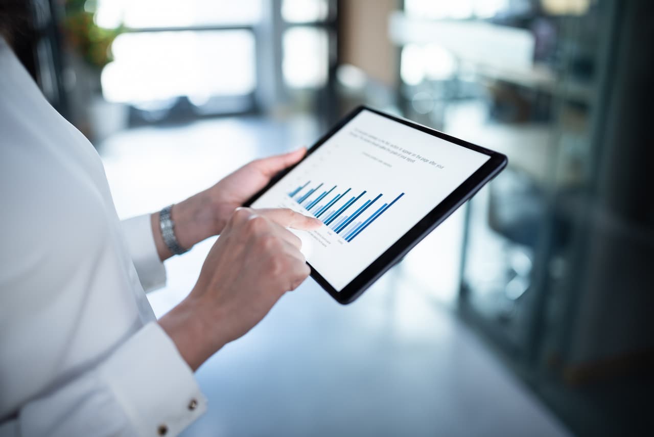 Business person reviewing figures on a tablet