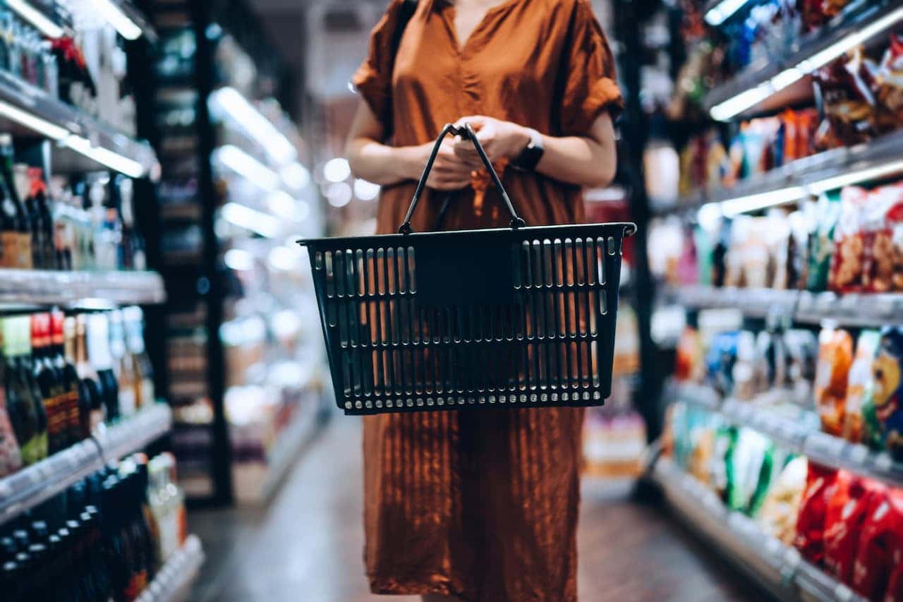 Person carrying a shopping basket