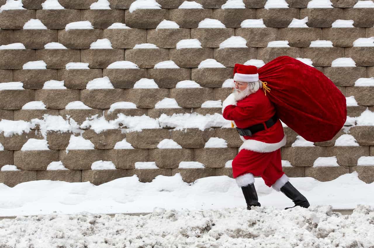 Santa claus carrying a sack in the snow