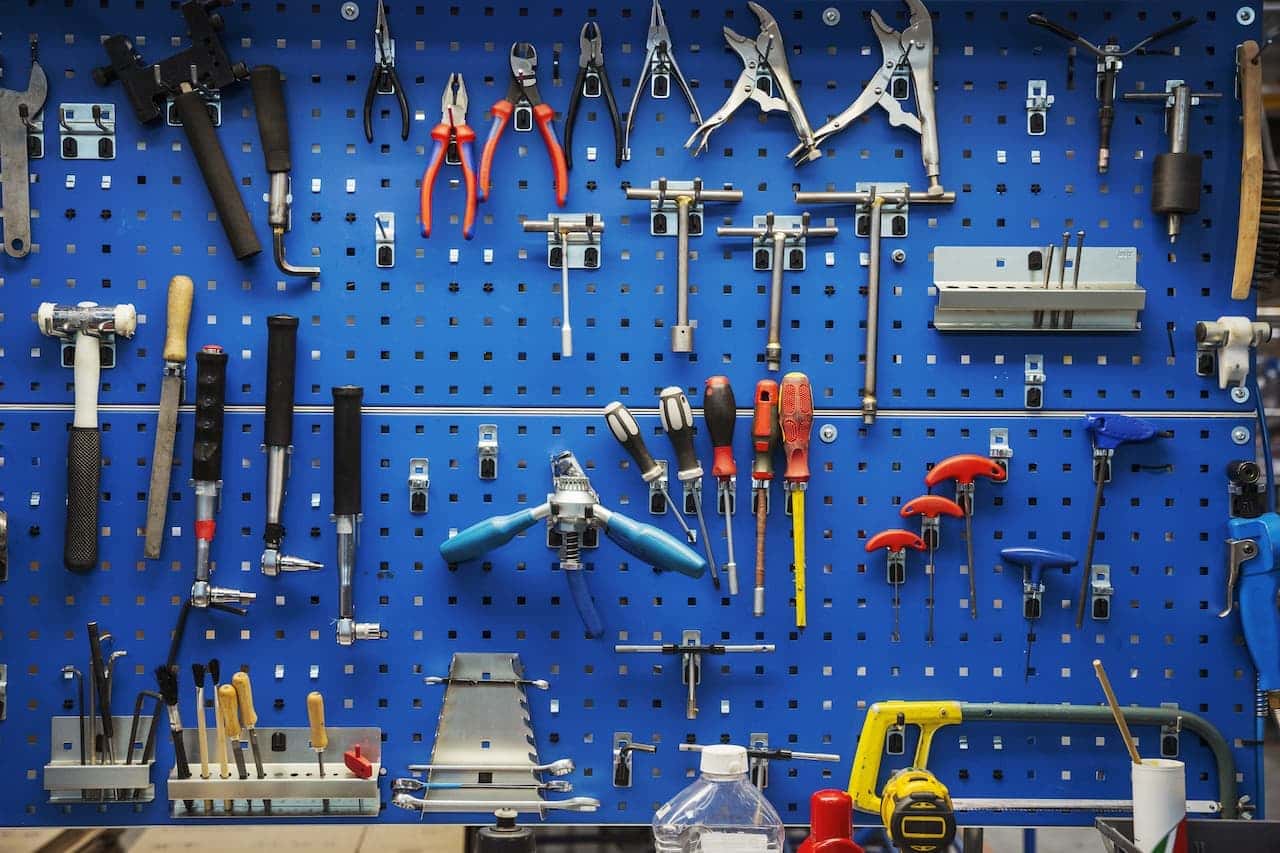 Blue tool rack with a selection of tools on display