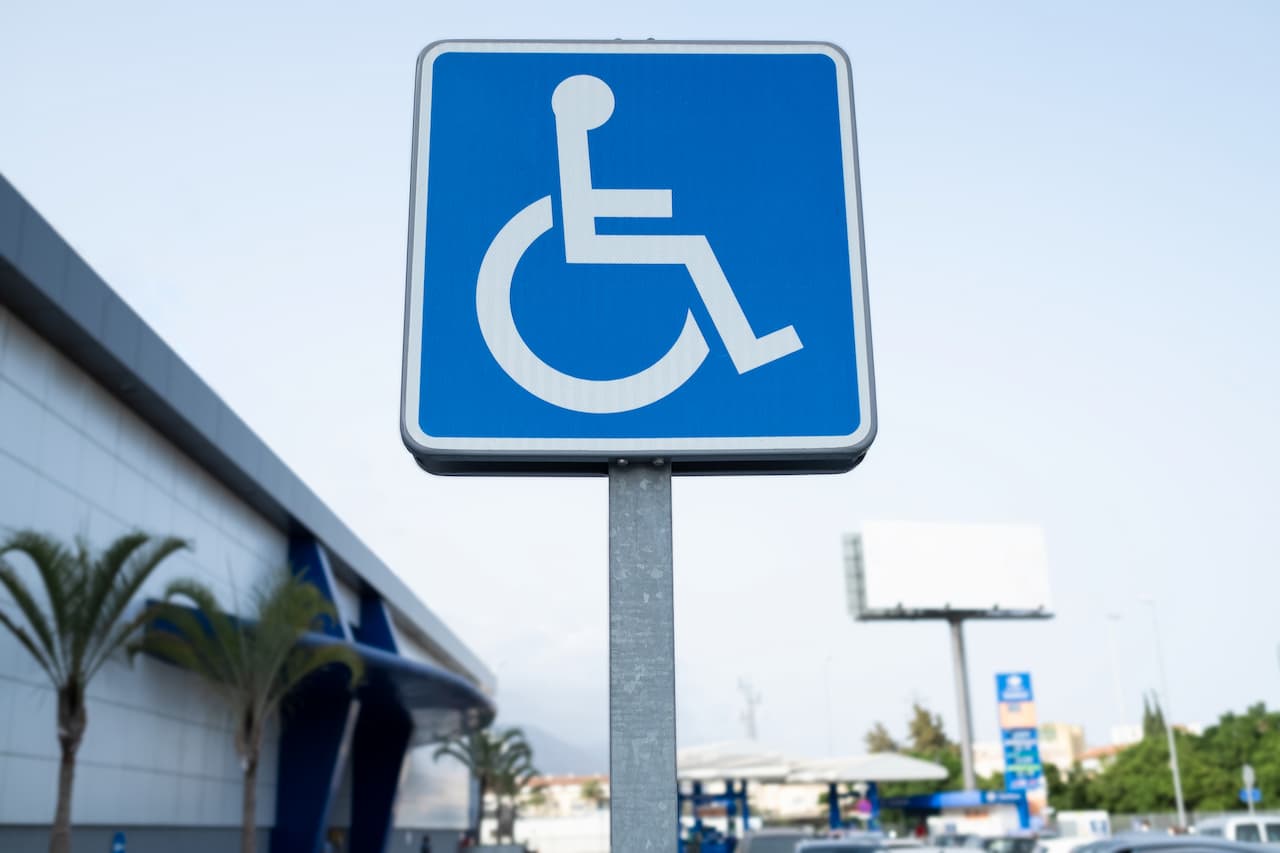 Blue disabled parking space sign in car park