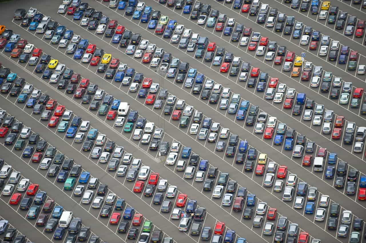 Large business car park with rows of parked cars