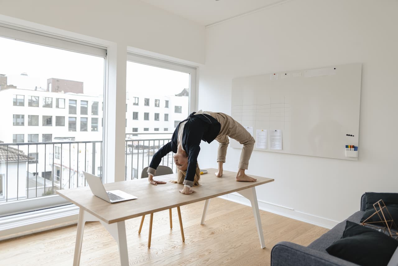 Person doing yoga on an office desk