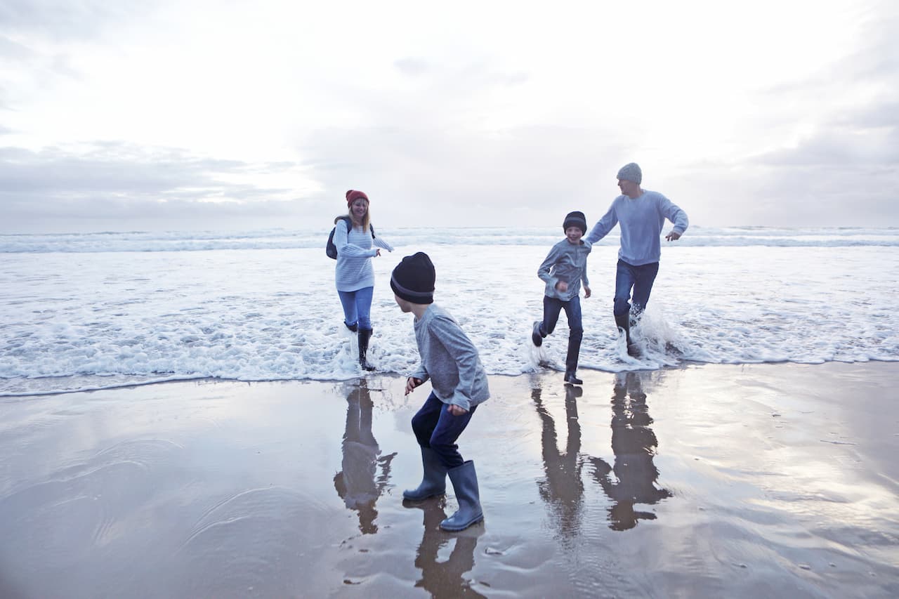 Family with children playing on the beach