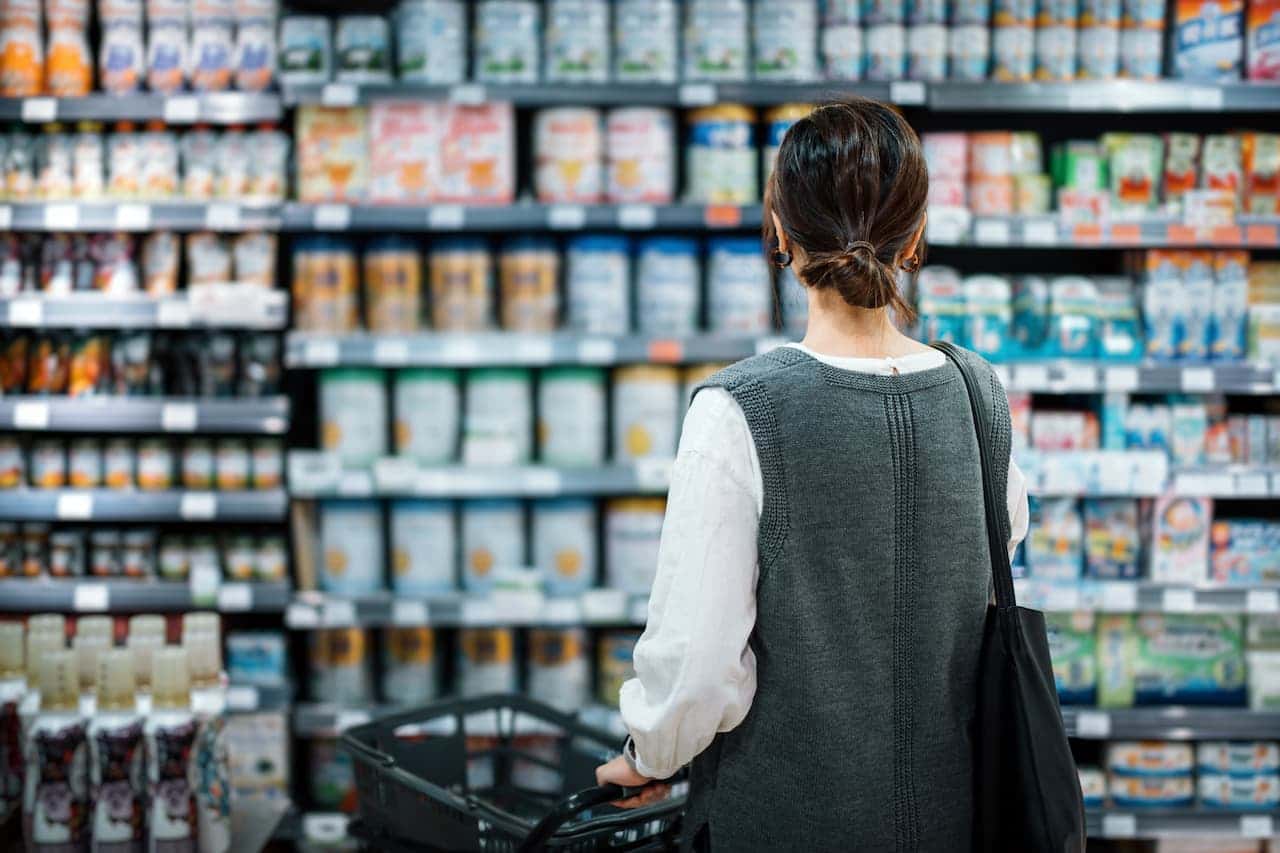 Person browsing products in a supermarket