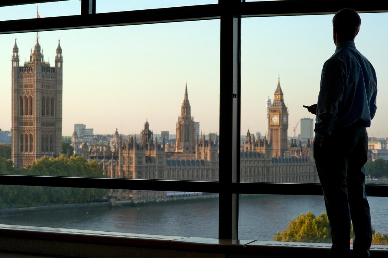Business person overlooking the Houses of Parliament