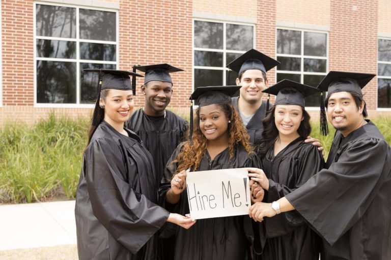 University graduates holding a sign that says hire me