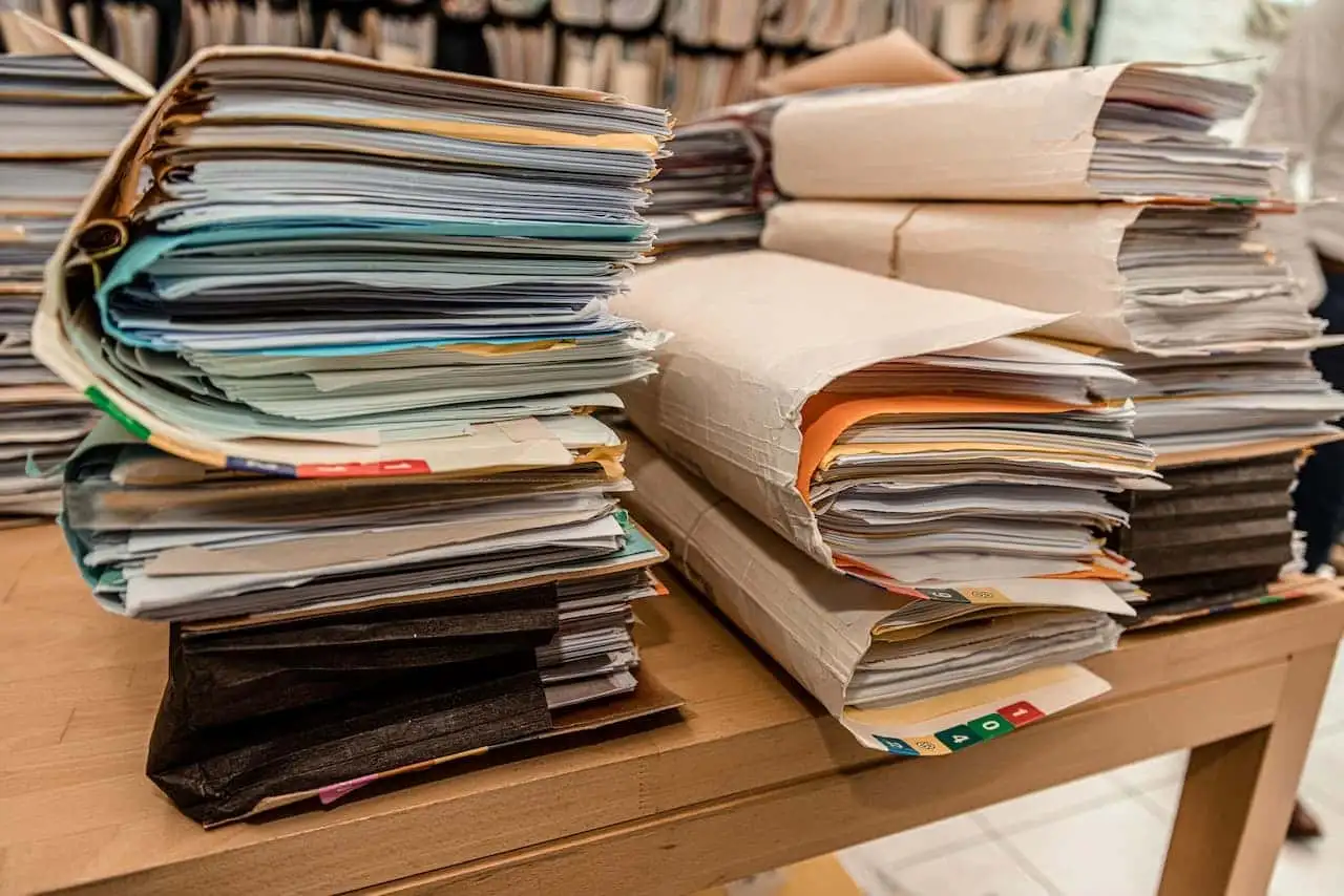 Stacks of folders containing business documents