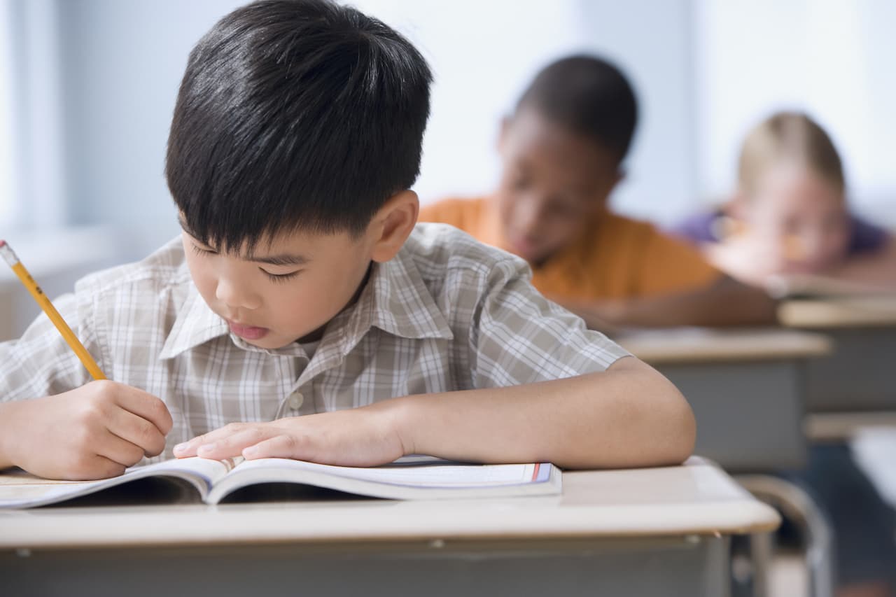 Child writing in a school book