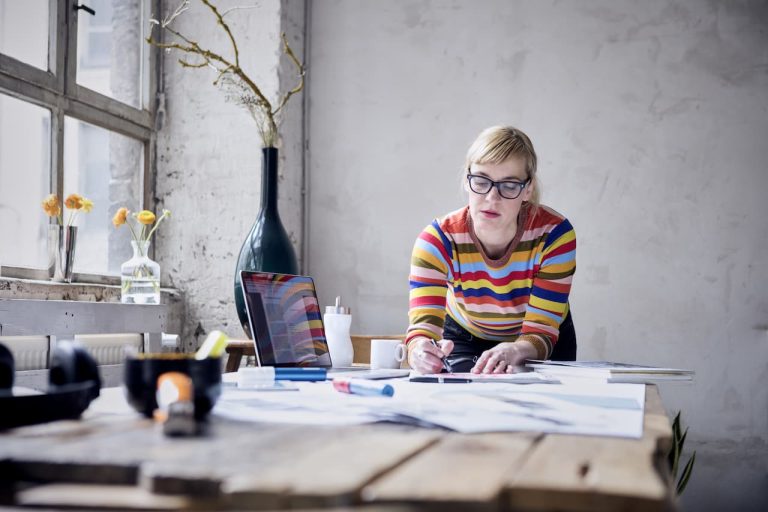 Person working on papers at a desk