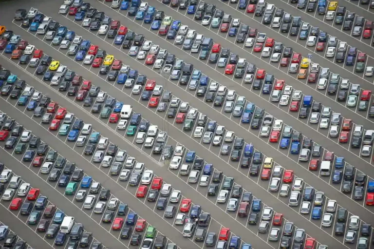 Large business car park with rows of parked cars