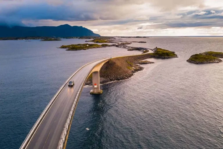 Car driving on a long bridge over water