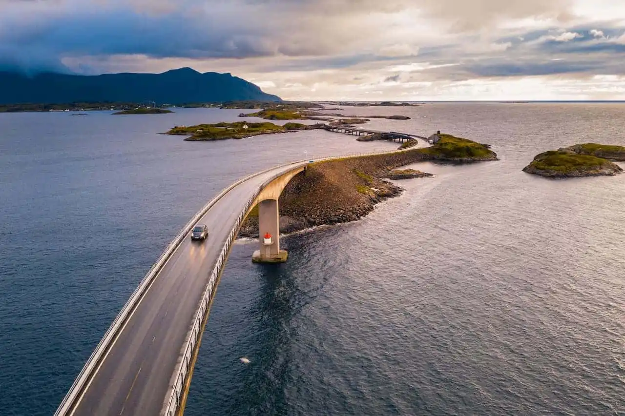Car driving on a long bridge over water