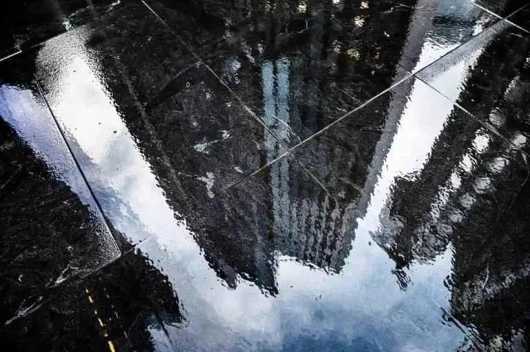 Business district reflection in a puddle