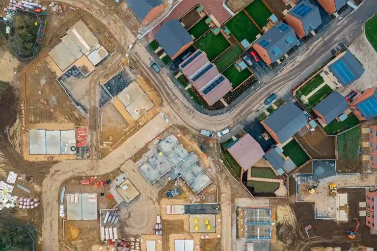 Aerial view of a residential construction site with completed houses and ongoing work.