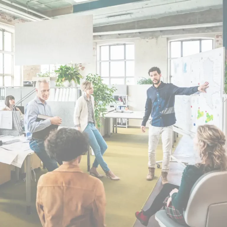 Several colleagues conversing in an office, sharing ideas and collaborating on a project.