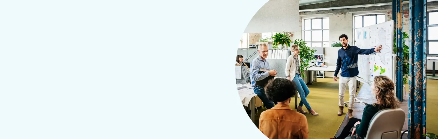 Several colleagues conversing in an office, sharing ideas and collaborating on a project.