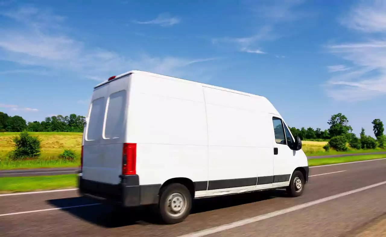 White van driving on the open road