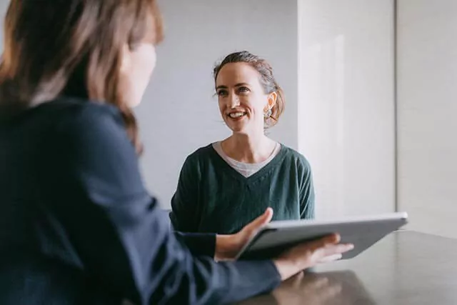 A web developer designer is discussing with a client during a meeting.