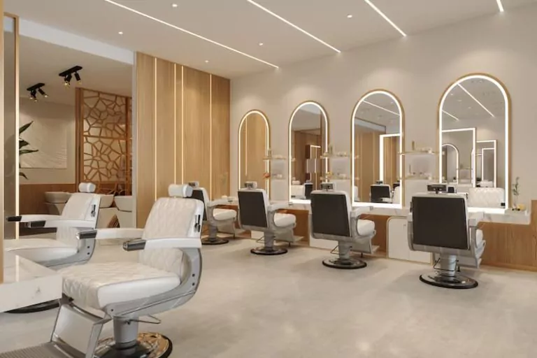 An elegant salon with white chairs and mirrors, providing a professional environment for hairdressers and barbers