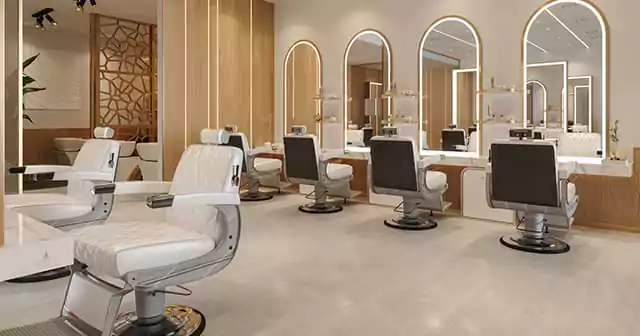 An elegant salon with white chairs and mirrors, providing a professional environment for hairdressers and barbers